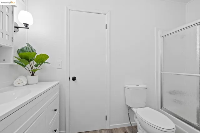 a view of a backyard with a patio and wooden fence
