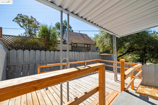 a balcony with wooden floor and outdoor seating