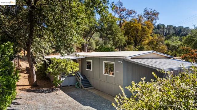 an aerial view of a house with a yard and garden