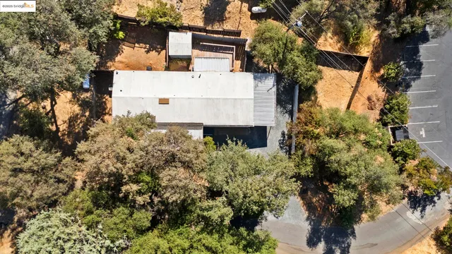an aerial view of a house with a yard and garden