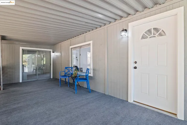 a view of a hallway with wooden table and chairs