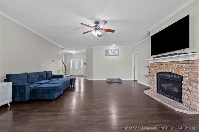 a living room with furniture fireplace and flat screen tv