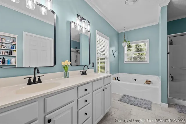 a spacious bathroom with double sink a large mirror and a shower