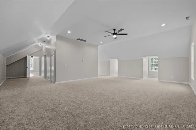 a view of empty room with ceiling fan