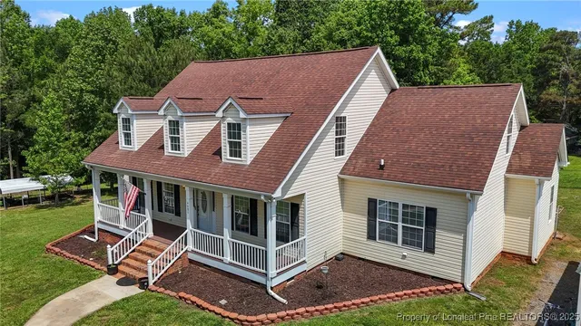 a aerial view of a house with a yard and balcony
