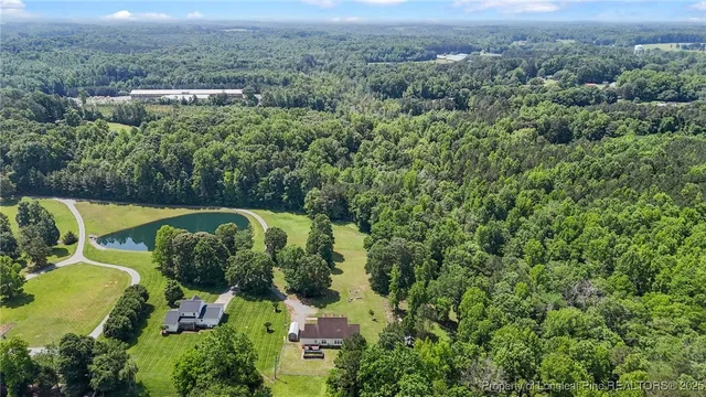 an aerial view of a house with a yard and lake view