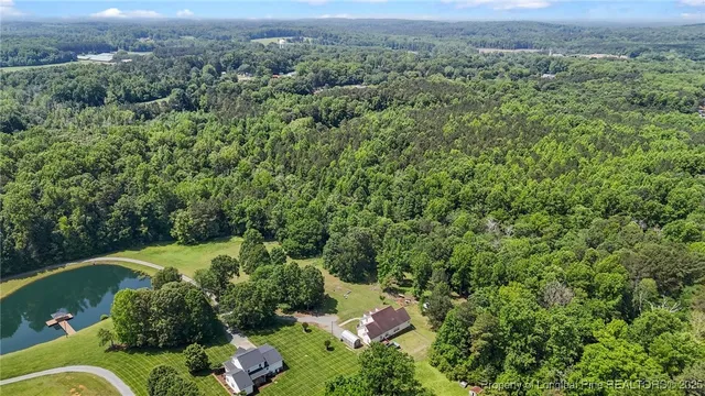 an aerial view of a house with a yard