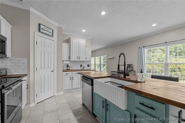 a kitchen with a sink stove and cabinets