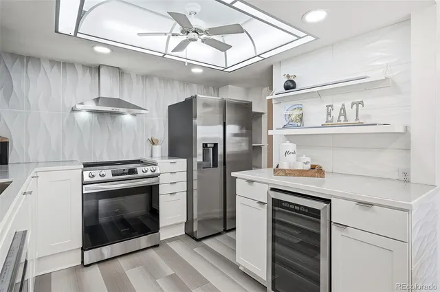 a kitchen with cabinets and stainless steel appliances
