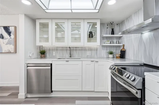 a kitchen with stainless steel appliances granite countertop a stove and a sink