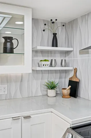 a kitchen with a potted plant on the counter and cabinets