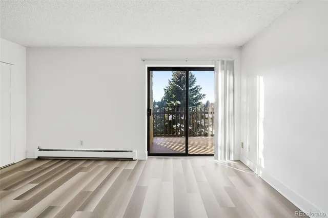 a view of an empty room with glass door