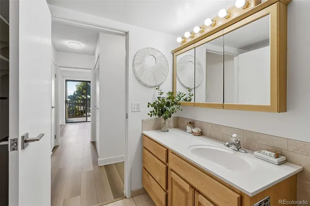 a bathroom with a sink mirror and vanity