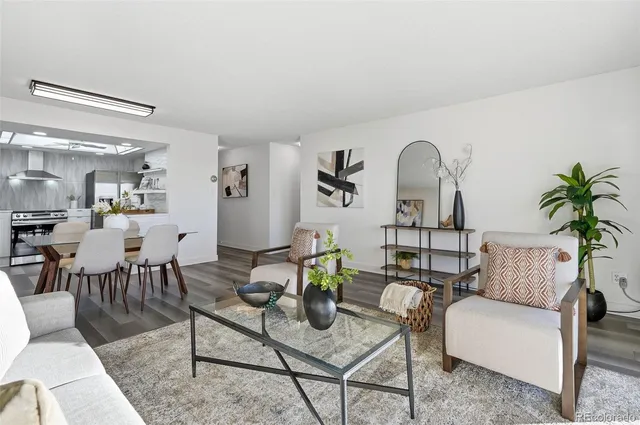 a living room with furniture a rug and a chandelier