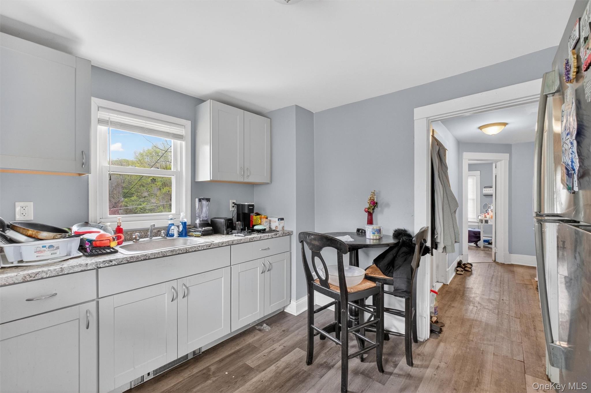 299 Peekskill Hollow Road Putnam Valley, NY 10579 - Photo 27 of 37 a kitchen with a dining table chairs and white cabinets
