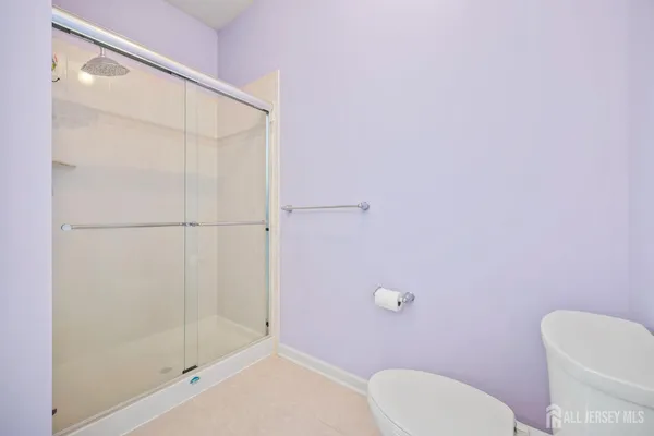 a bathroom with a shower a toilet and sink