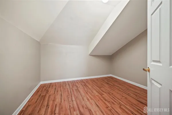 a view of a room with wooden floor