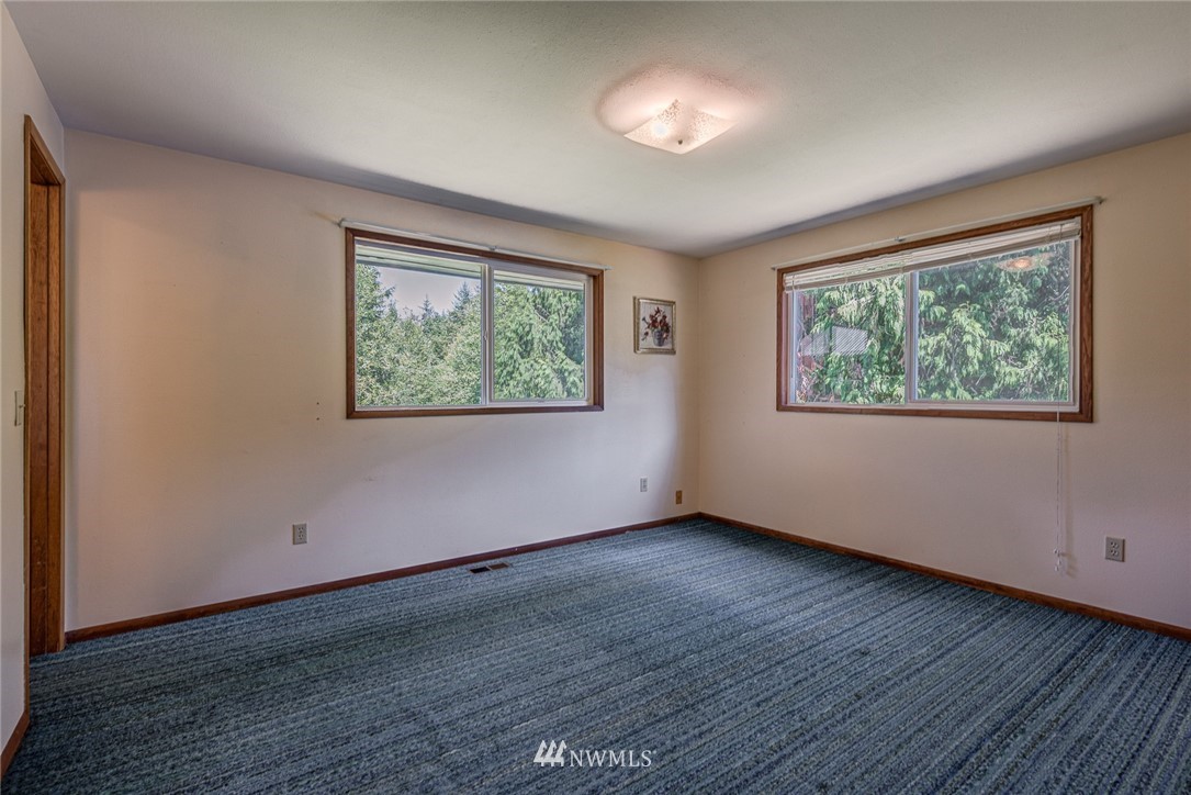17111 Newberg Road Snohomish, WA 98290 - Photo 22 of 37 a view of an empty room with wooden floor and a window