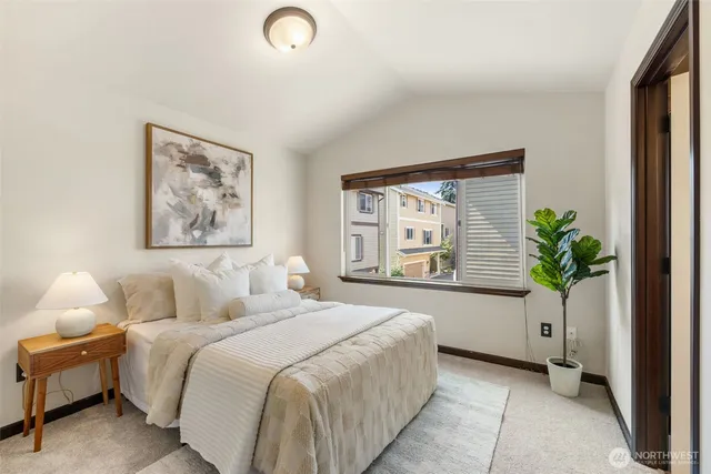 a bedroom with a bed and a large window