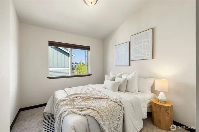 a bedroom with a bed and a window