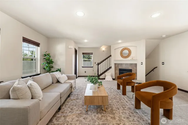 a living room with furniture a fireplace and a table
