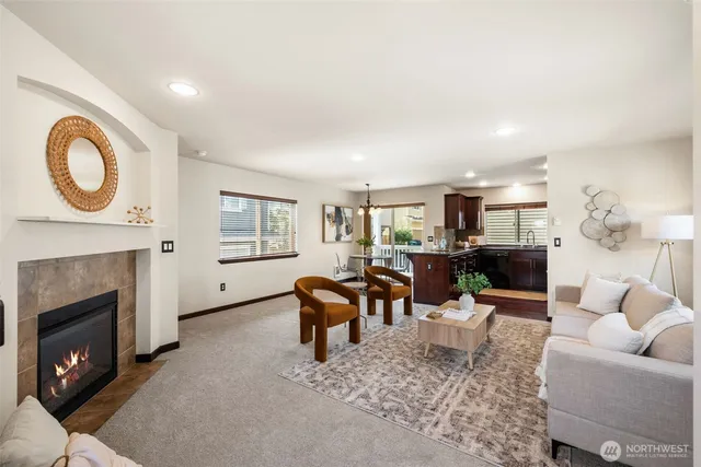 a living room with furniture a window and a fireplace