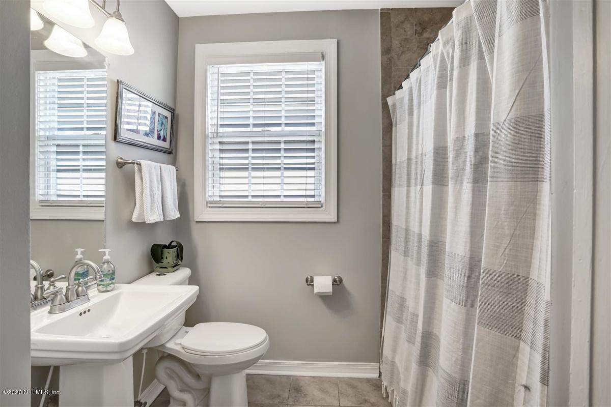 3940 Gadsden Road Jacksonville, FL 32207 - Photo 13 of 17 a bathroom with a sink a toilet and a mirror