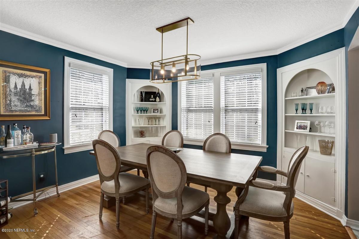 3940 Gadsden Road Jacksonville, FL 32207 - Photo 5 of 17 a dining room with furniture a chandelier and window