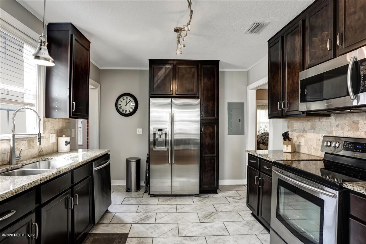 3940 Gadsden Road Jacksonville, FL 32207 - Photo 7 of 17 a kitchen with stainless steel appliances granite countertop a refrigerator a stove a sink and a microwave
