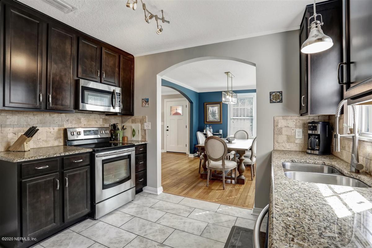 3940 Gadsden Road Jacksonville, FL 32207 - Photo 8 of 17 a view of a kitchen with granite countertop a stove top oven a sink a dining table and chair