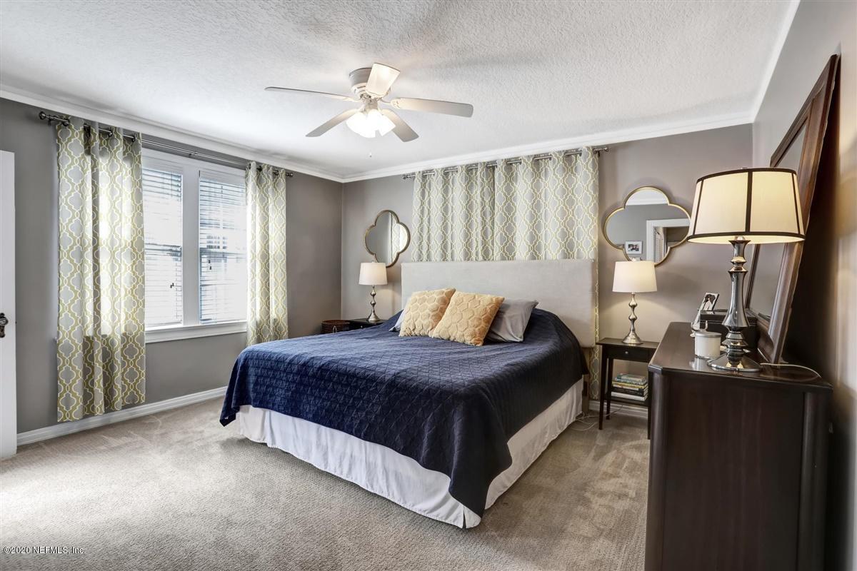 3940 Gadsden Road Jacksonville, FL 32207 - Photo 9 of 17 a spacious bedroom with a bed a dresser and windows