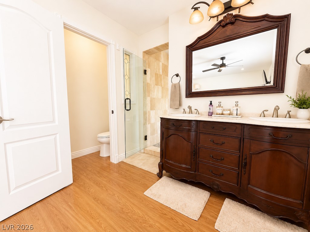 3010 East Viking Road Las Vegas, NV 89121 - Photo 16 of 48 Double vanity sinks and a spacious shower elevate this elegant primary bathroom.