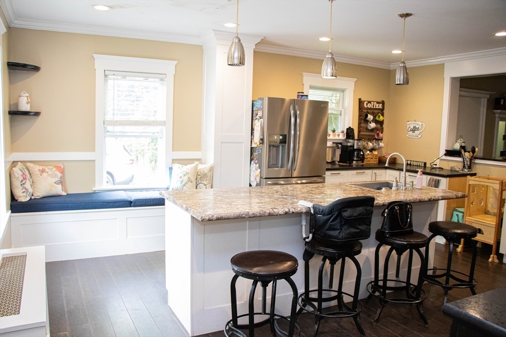 85-87 Slater Street Webster, MA 01570 - Photo 5 of 41 a kitchen with granite countertop a sink and chairs