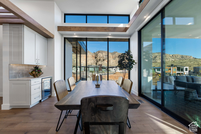 3558 South Cypress Road Hurricane, UT 84737 - Photo 10 of 57 Dining room with a mountain view, dark hardwood / wood-style floors, and beverage cooler