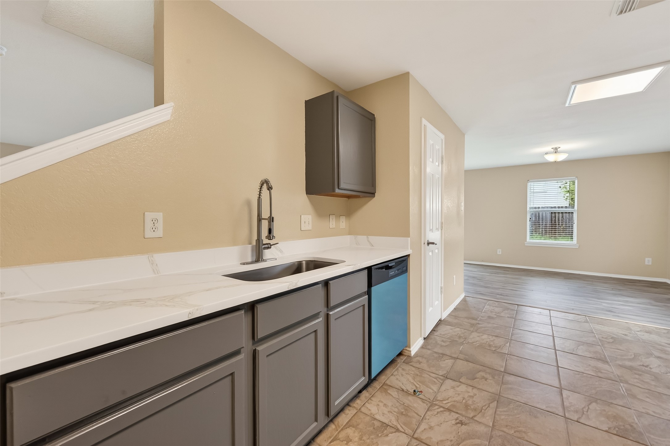 22802 Sherioaks Lane Spring, TX 77389 - Photo 8 of 37 The staircase is centrally located, with kitchen on one side and the living area on the other, creates a functional and well balanced layout.