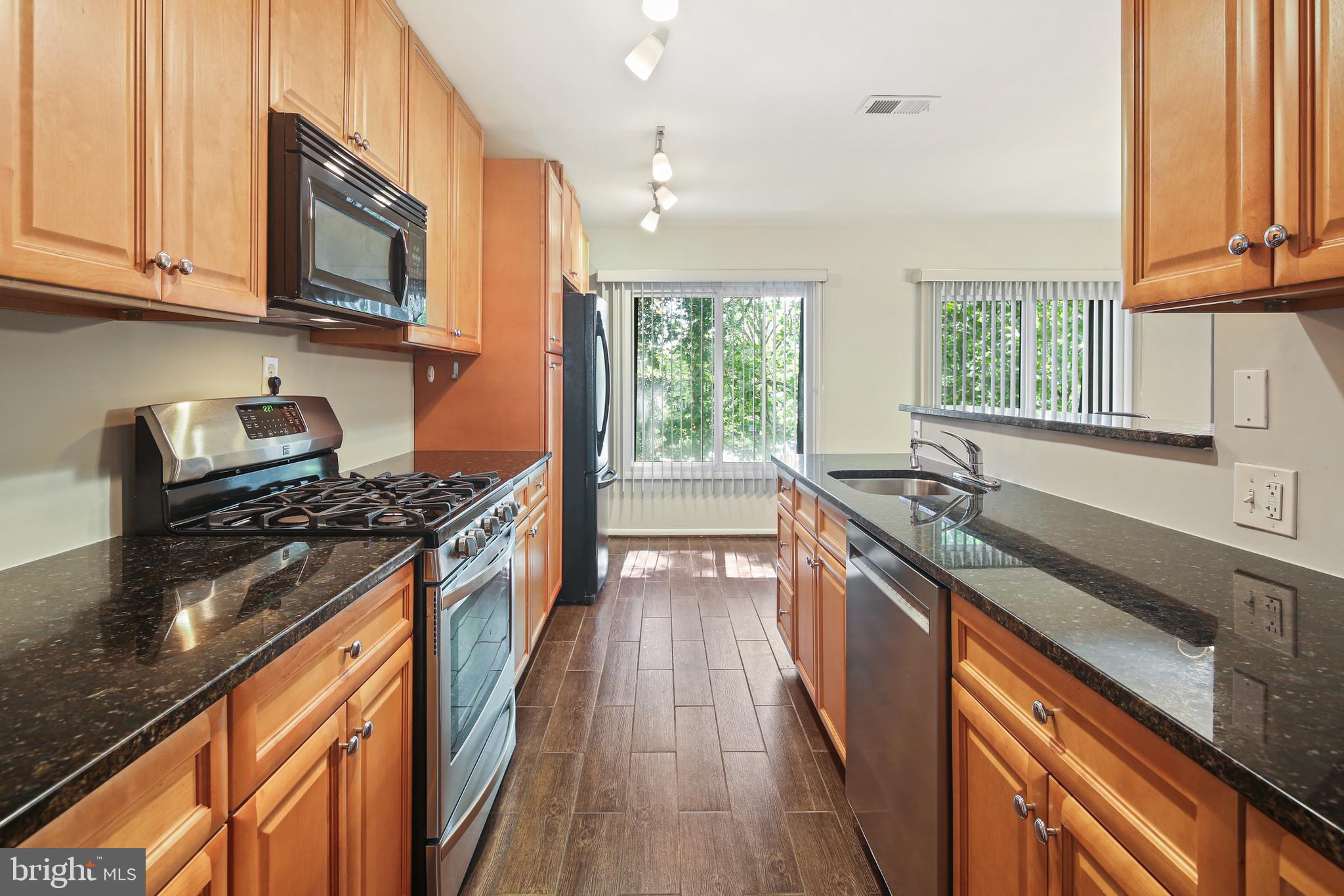 5239 West Running Brook Road, Unit 301 Columbia, MD 21044 - Photo 1 of 33 a kitchen with stainless steel appliances granite countertop a stove and a sink