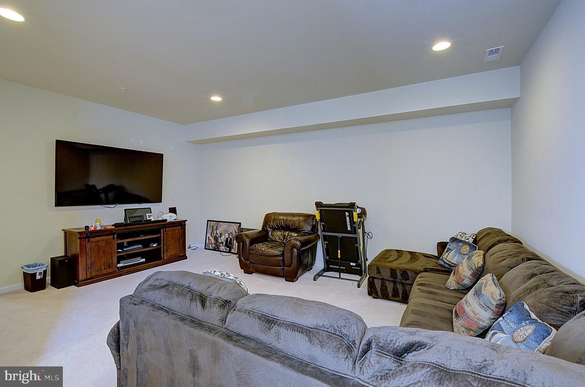 12801 Ricker Road Upper Marlboro, MD 20772 - Photo 12 of 27 a living room with furniture and a flat screen tv
