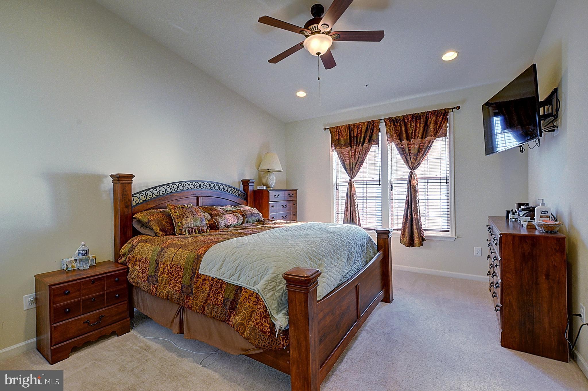 12801 Ricker Road Upper Marlboro, MD 20772 - Photo 15 of 27 a bedroom with a bed and a flat tv screen on a dresser