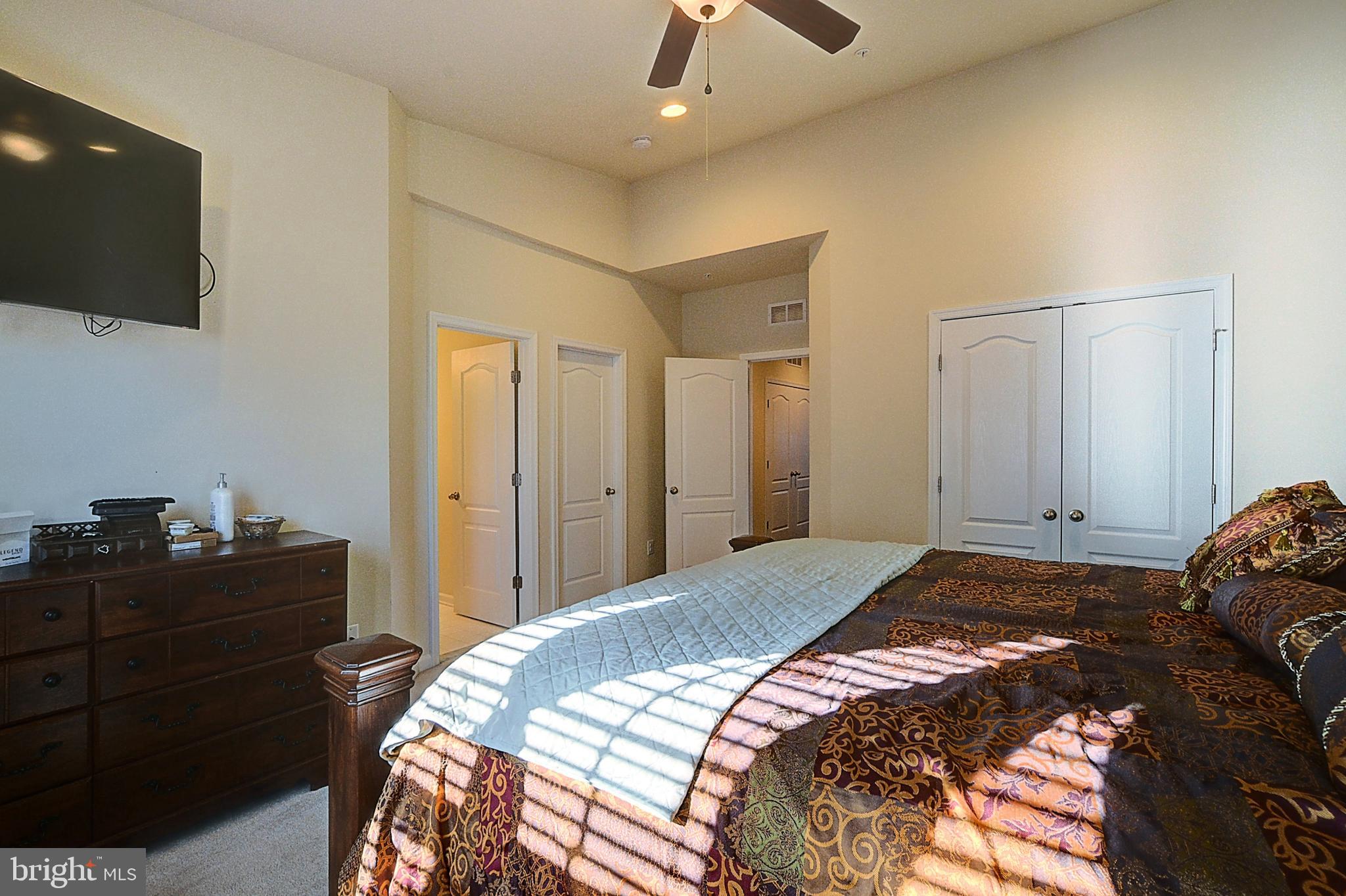 12801 Ricker Road Upper Marlboro, MD 20772 - Photo 17 of 27 a bedroom with a bed and a flat screen tv