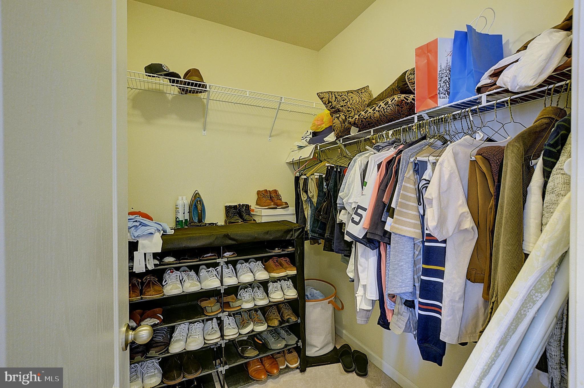 12801 Ricker Road Upper Marlboro, MD 20772 - Photo 20 of 27 a view of walk in closet with clothes and shoes