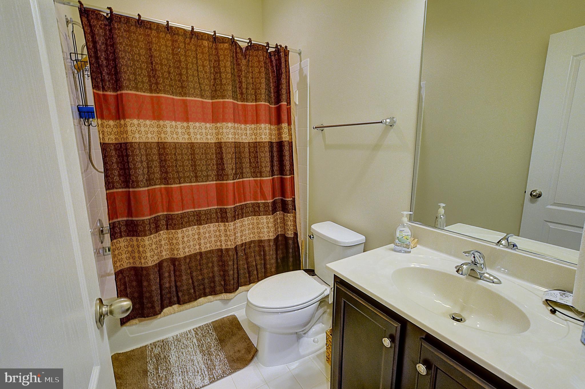 12801 Ricker Road Upper Marlboro, MD 20772 - Photo 22 of 27 a bathroom with a sink toilet and shower