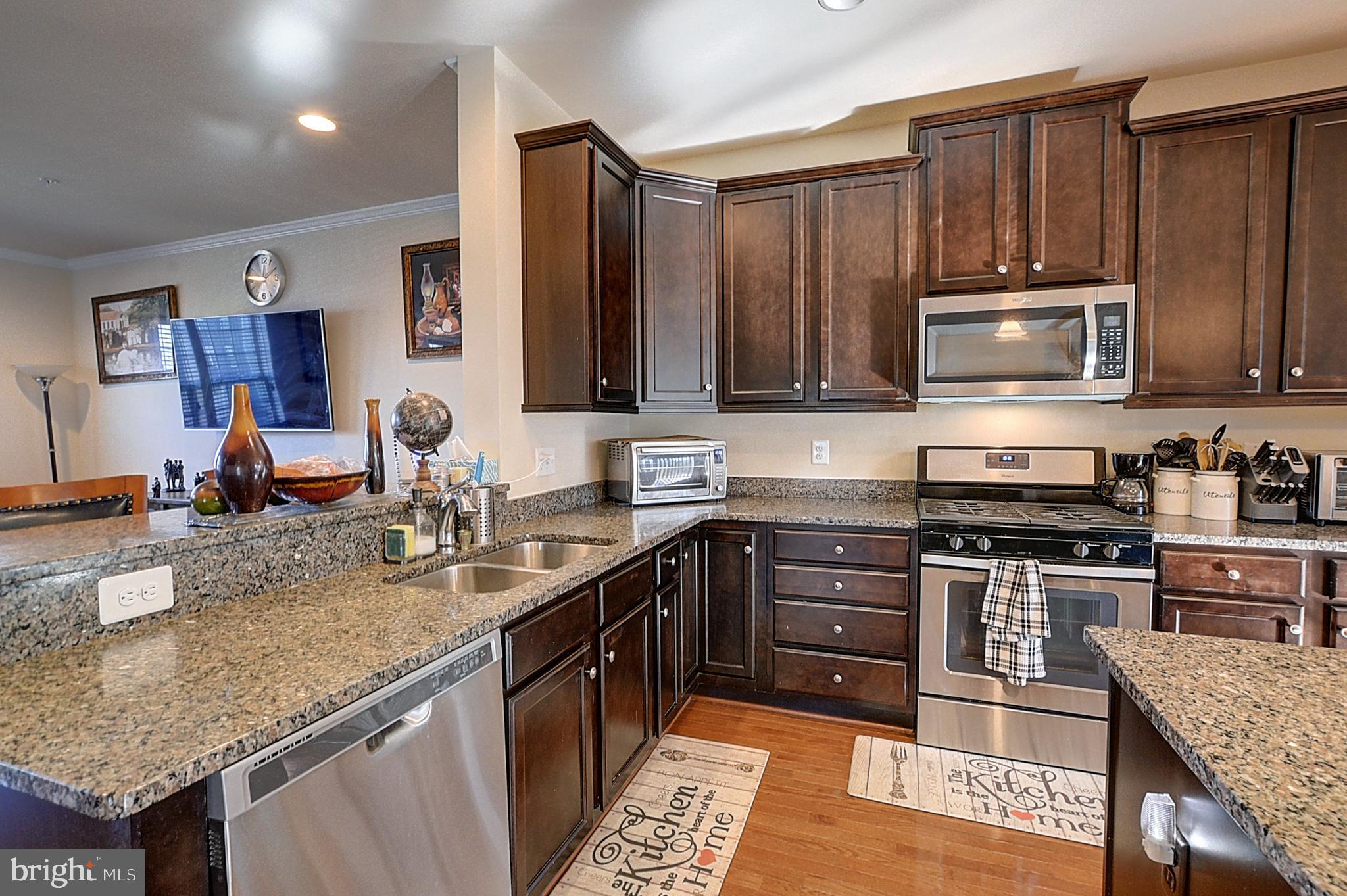 12801 Ricker Road Upper Marlboro, MD 20772 - Photo 9 of 27 a kitchen with stainless steel appliances granite countertop a stove a sink and a microwave