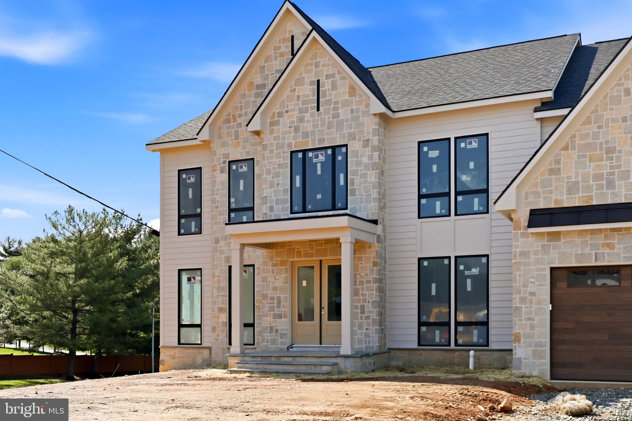 10801 Mason Hunt Court Reston, VA 20190 - Photo 6 of 26 a view of a brick house with large windows