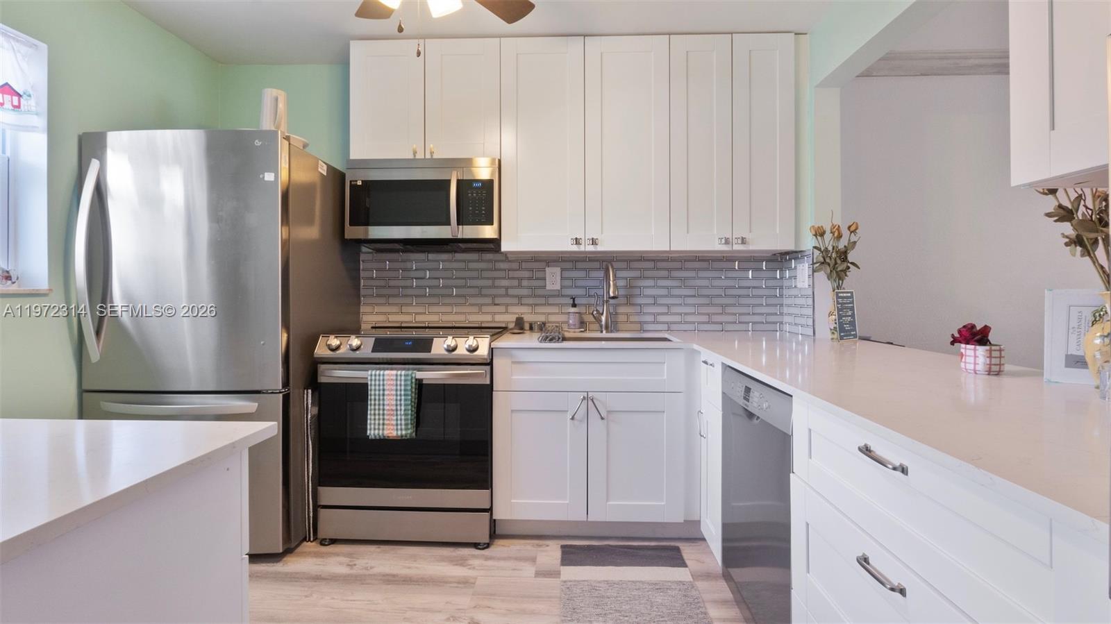 a kitchen with a sink stainless steel appliances and cabinets