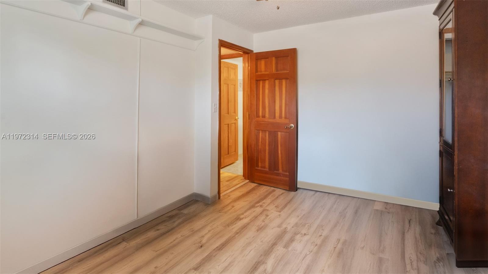 8605 West Sample Road, Unit 202 Coral Springs, FL 33065 - Photo 14 of 26 a view of an empty room with closet and a window
