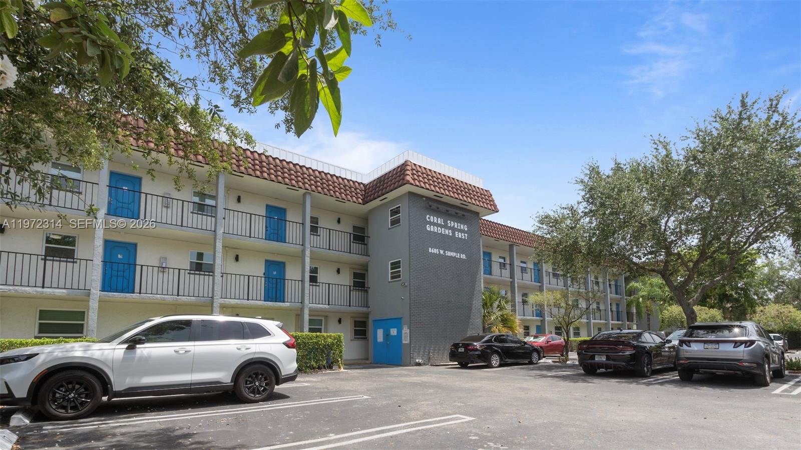 8605 West Sample Road, Unit 202 Coral Springs, FL 33065 - Photo 16 of 26 a view of cars parked in front of a building