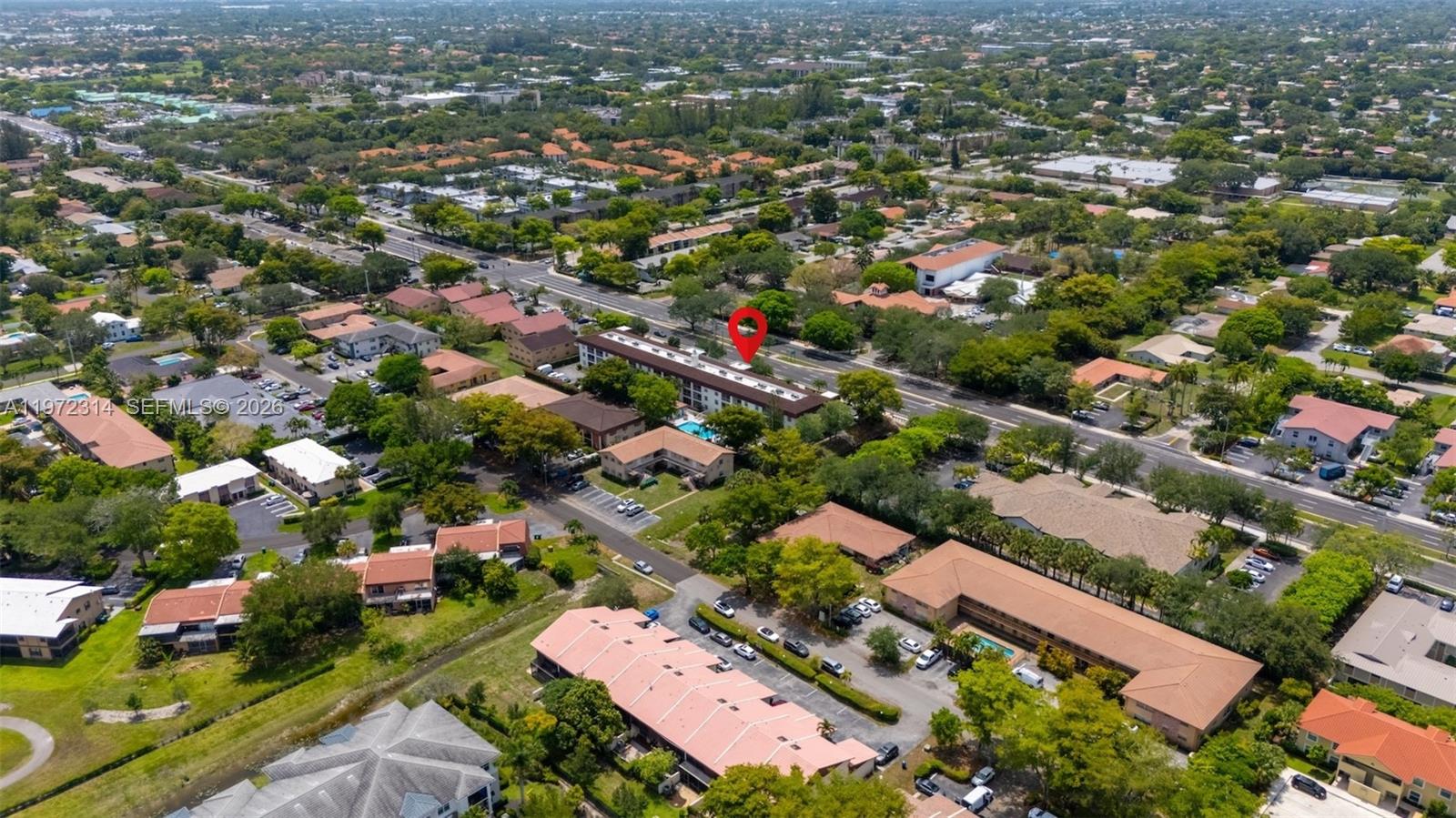 8605 West Sample Road, Unit 202 Coral Springs, FL 33065 - Photo 21 of 26 an aerial view of residential houses with outdoor space and trees