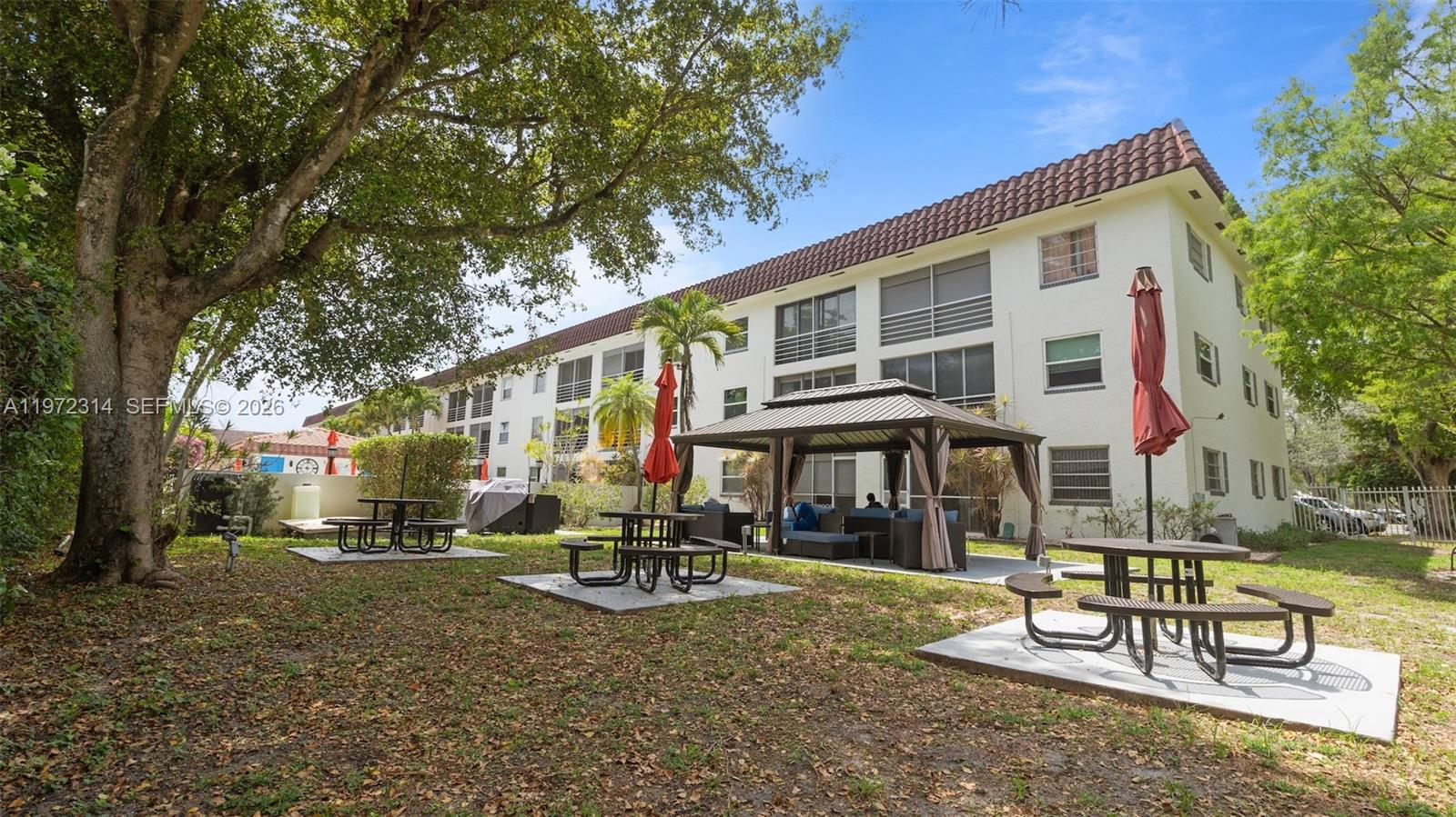 8605 West Sample Road, Unit 202 Coral Springs, FL 33065 - Photo 25 of 26 a front view of a building with sitting area