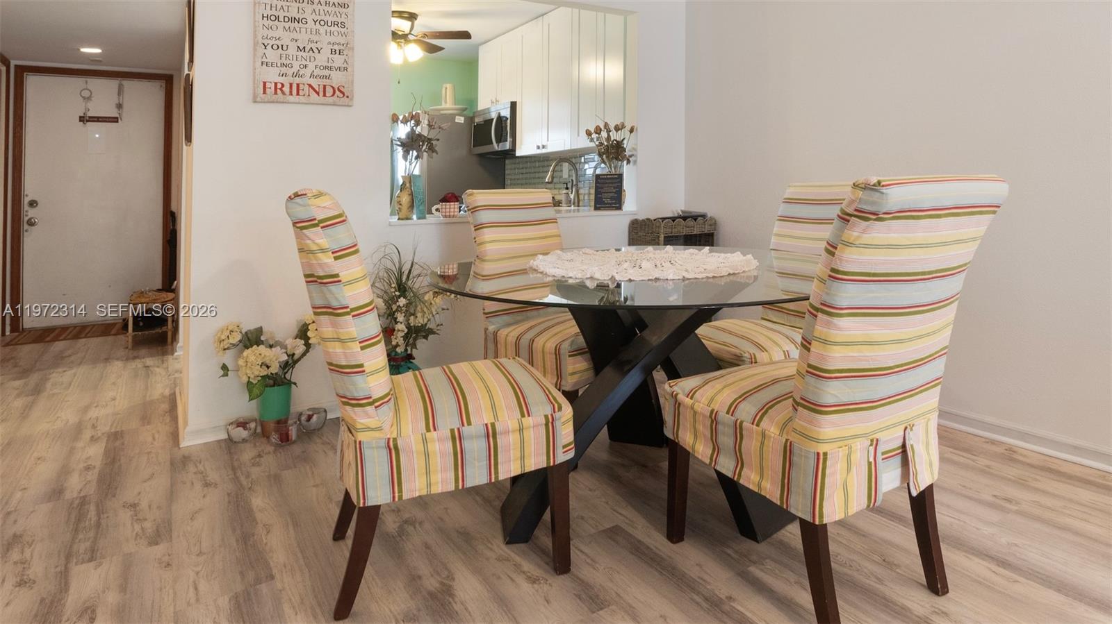 8605 West Sample Road, Unit 202 Coral Springs, FL 33065 - Photo 5 of 26 a view of a dining room with furniture and wooden floor