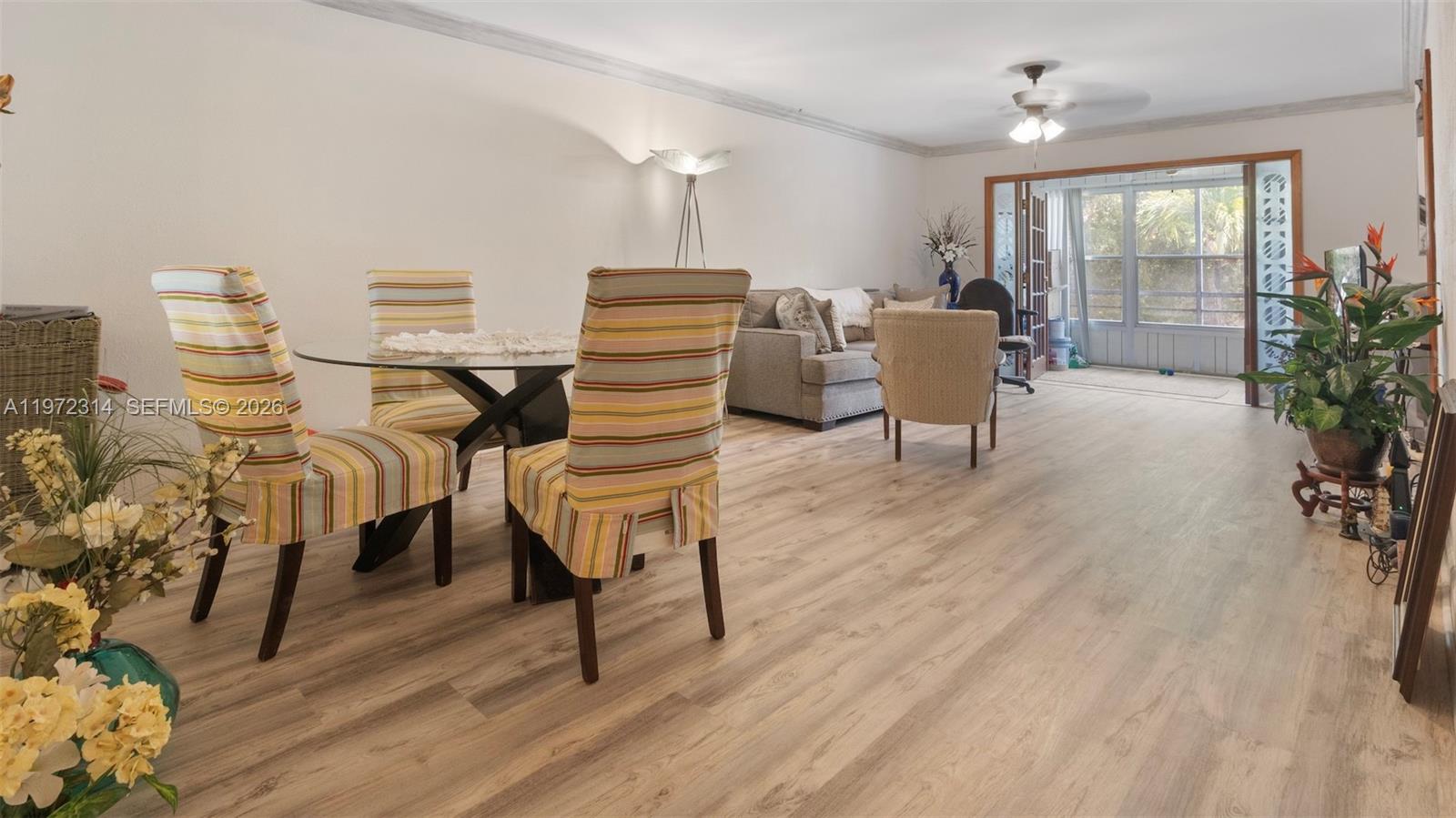 8605 West Sample Road, Unit 202 Coral Springs, FL 33065 - Photo 6 of 26 a living room with furniture and a wooden floor